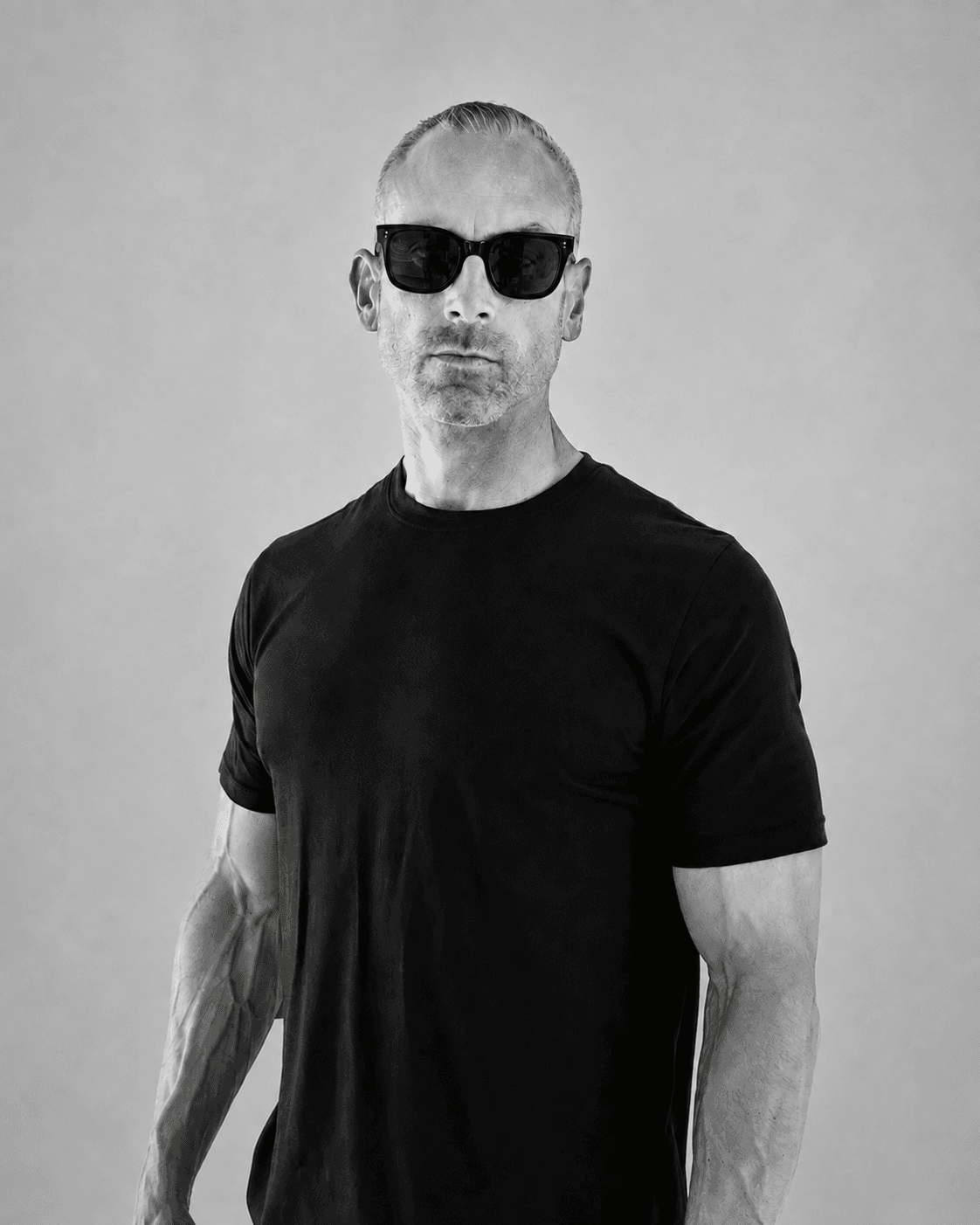 DJ Bam Bam, black-and-white portrait wearing sunglasses